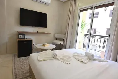 a bedroom with a white bed with a large window at Suite Jasmin Elegance a Gueliz in Marrakech