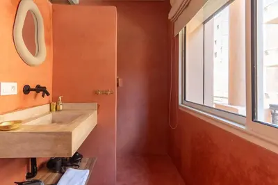 a bathroom with a wooden sink and a window at Suite Sirocco - Confort a Gueliz in Marrakech