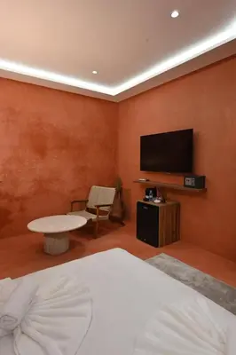 a bedroom with a bed and a flat screen tv at Suite Sirocco - Confort a Gueliz in Marrakech