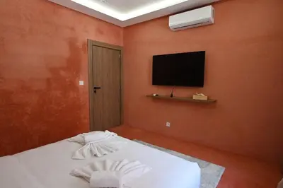 a bedroom with a bed with a flat screen tv at Suite Safran - Ambiance berbere in Marrakech