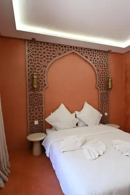 a bedroom with a large bed with white pillows at Suite Safran - Ambiance berbere in Marrakech