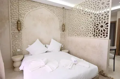 a bedroom with a white bed with bows on it at Suite Ivoire - Elegance a Gueliz in Marrakech