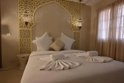 a bedroom with a bed with two towels on it at Suite Oxyde - Elegance douce in Marrakech
