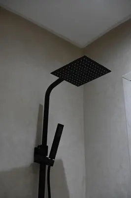 a black lamp in the corner of a room at Suite Oxyde - Elegance douce in Marrakech
