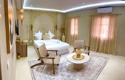 a bedroom with a bed and a table and chairs at Suite Oasis - cosy et moderne in Marrakech