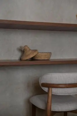 two baskets sitting on a shelf next to a chair at Suite Atlas - Douceur et confort in Marrakech