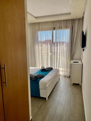 a bedroom with a bed and a large window at Small 1-bedroom apartment perfect for discovering Marrakech in Marrakech