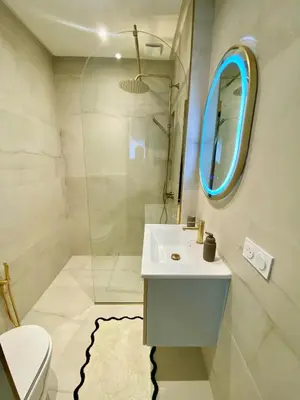 a bathroom with a sink and a mirror at Beautiful winter apartment with private hot tub in Marrakech