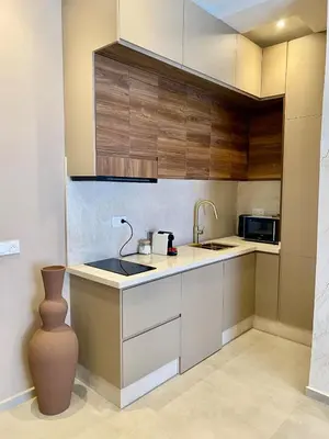 a small kitchen with a sink and a microwave at Beautiful winter apartment with private hot tub in Marrakech