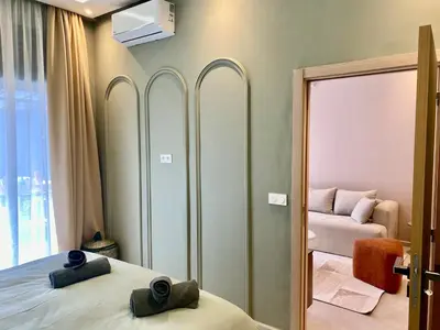 a bedroom with a mirror and a bed and a couch at Beautiful winter apartment with private hot tub in Marrakech