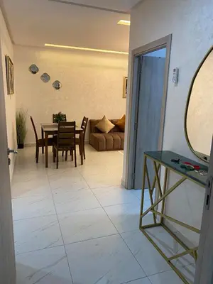 a living room with a table and chairs and a couch at Very nice apartment on Route de Casa in Marrakech