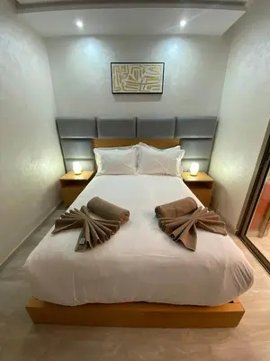 a bedroom with a large white bed with two night stands at Very nice apartment on Route de Casa in Marrakech