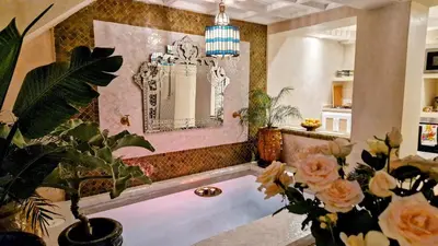 a room with a mirror and some plants and flowers at Dar Riad Sidi Duri en exclusivité 7 P with private Pools in Marrakech