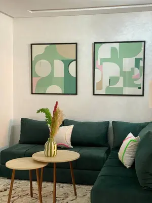 a living room with a green couch and a table at Moulay Youssef in Marrakech