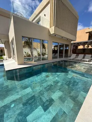 a large swimming pool in front of a house at Villa 289- Charme Balinais in Marrakech