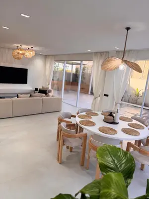 a living room with a couch and a table and chairs at Villa 289- Charme Balinais in Marrakech