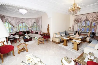a large living room filled with furniture and a chandelier at Villa Marrakech in Marrakech