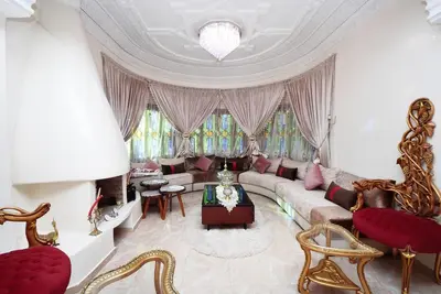 a living room with a couch and a table at Villa Marrakech in Marrakech