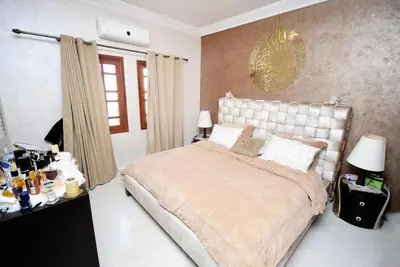 a bedroom with a large bed and a chandelier at Villa Marrakech in Marrakech