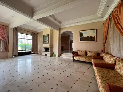 a large living room with a couch and a fireplace at ksar el bahja in Marrakech