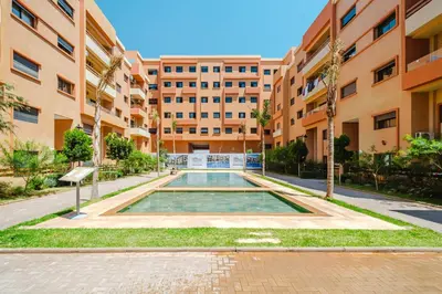 a swimming pool in the middle of a building at Charming Apartment Guéliz Pool-Parking 24h-7j Security 10 a pied de M Avenue in Marrakech