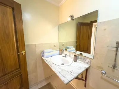 a bathroom with a sink and a mirror at Majorelle Cozy Apartment Garden 2-Balcony Downtown in Marrakech