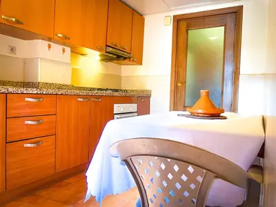 a kitchen with a table with a lamp on it at Majorelle Cozy Apartment Garden 2-Balcony Downtown in Marrakech