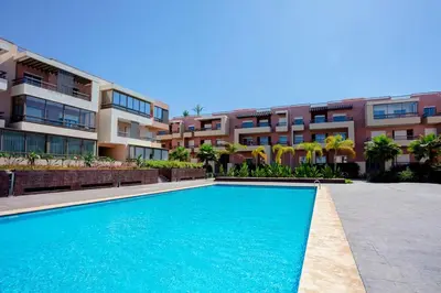 a swimming pool in front of a apartment building at L'ambiance de Marrakech Luxe in Marrakech