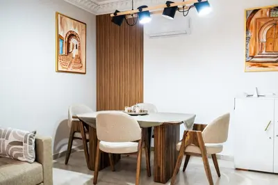 a dining room with a table and chairs at Hivernage, piscine & jardin privé in Marrakech