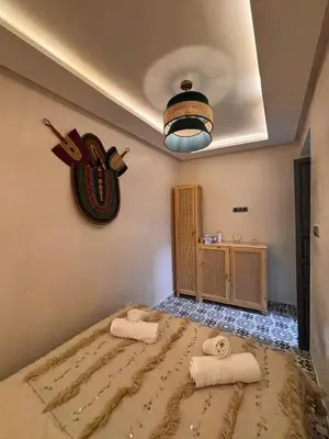 a bedroom with a bed with towels on it at DAR ZINA - Heart of Medina, Marrakech in Marrakech
