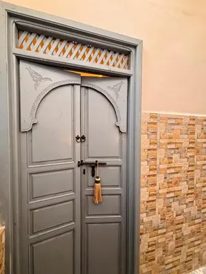 a gray door with a tassel at DAR ZINA - Heart of Medina, Marrakech in Marrakech