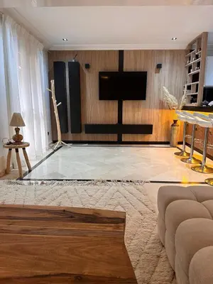 a living room with a flat screen tv on a wall at MY LOCANA - Appartement Gueliz Jaccuzi in Marrakech