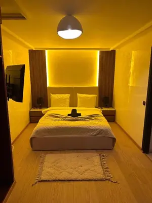 a bedroom with a bed and a tv in it at MY LOCANA - Appartement Gueliz Jaccuzi in Marrakech