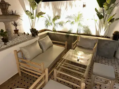 a balcony with a couch and chairs and plants at MY LOCANA - Appartement Gueliz Jaccuzi in Marrakech