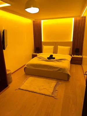 a bedroom with a bed with a laptop on it at MY LOCANA - Appartement Gueliz Jaccuzi in Marrakech