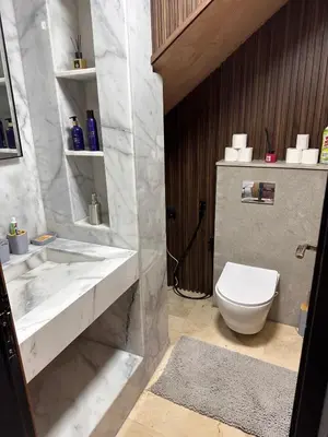 a bathroom with a white toilet and a sink at MY LOCANA - Appartement Gueliz Jaccuzi in Marrakech
