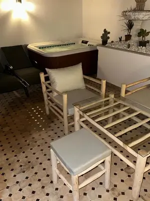 a room with a tub and a table and chairs at MY LOCANA - Appartement Gueliz Jaccuzi in Marrakech
