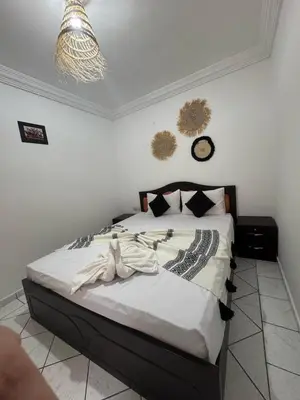 a bedroom with a large bed with white sheets at Riad Four Rooms & Pool in Marrakech