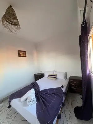 a bedroom with a bed with a blanket on it at Riad Four Rooms & Pool in Marrakech