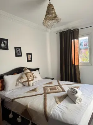 a bedroom with a bed with towels on it at Riad Four Rooms & Pool in Marrakech