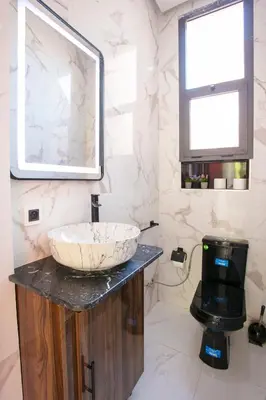 a bathroom with a sink and a mirror at Villa Sérénité Marrakech in Marrakech