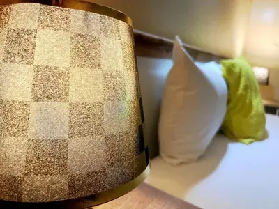 a pillow sitting on a bed next to a table at perle studio familial in Marrakech