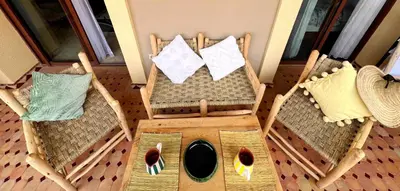 an overhead view of a dog house with two chairs at perle studio familial in Marrakech