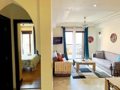a living room with a couch and a bed at perle studio familial in Marrakech
