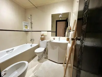 a bathroom with a sink and a toilet and a tub at perle studio familial in Marrakech