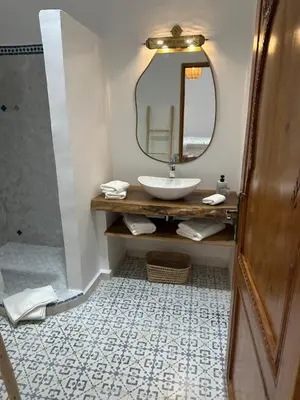 a bathroom with a sink and a mirror at Riad Reflet D'orient Marrakech in Marrakech