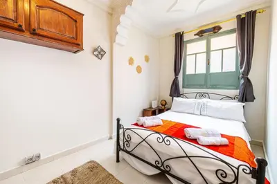 a bedroom with a bed and a window at 2BR Medina Home with Roof Terrace in Marrakech