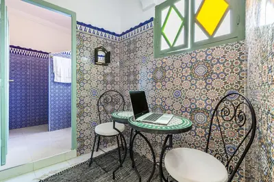 a room with a table with a laptop on it at 2BR Medina Home with Roof Terrace in Marrakech
