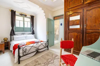 a bedroom with a bed and a desk and a laptop at 2BR Medina Home with Roof Terrace in Marrakech