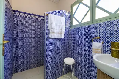 a blue bathroom with a sink and a shower at 2BR Medina Home with Roof Terrace in Marrakech